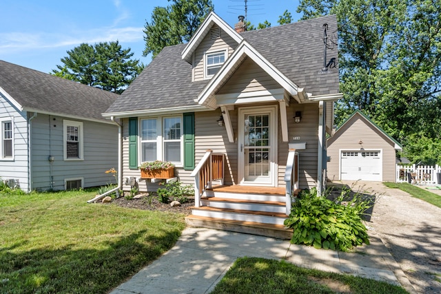 716 17th St, Jackson, MI 49203 - view of front of house featuring an outbuilding, concrete driveway, a shingled roof, a front lawn, and a garage