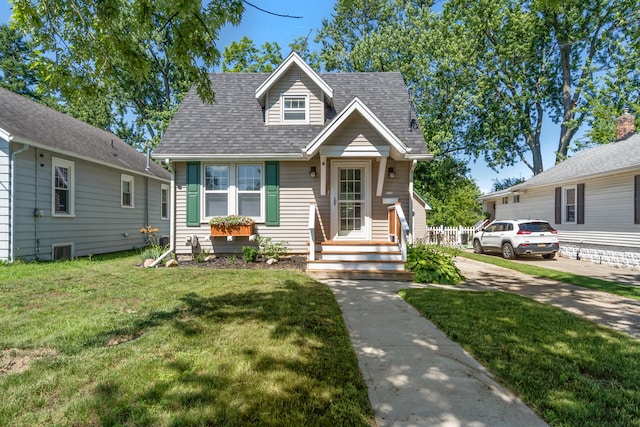 716 17th St, Jackson, MI 49203 - view of front of house with a front yard and roof with shingles