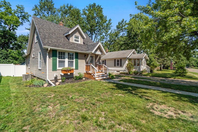 716 17th St, Jackson, MI 49203 - view of front of property featuring roof with shingles and a chimney