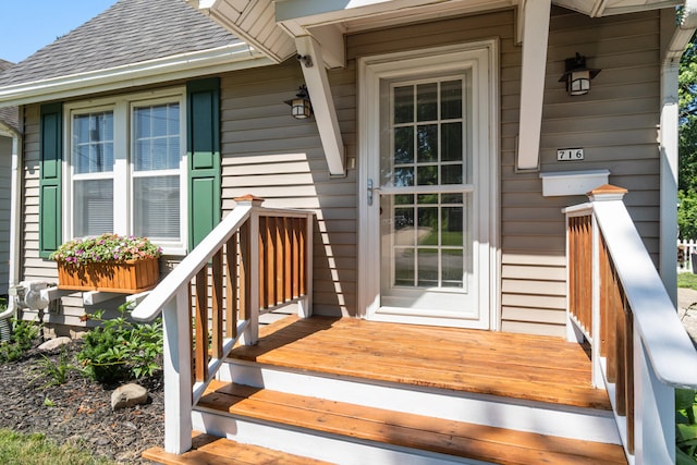 716 17th St, Jackson, MI 49203 - view of exterior entry featuring a shingled roof