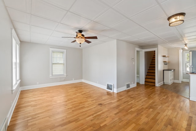 716 17th St, Jackson, MI 49203 - unfurnished living room featuring stairway, light wood-type flooring, and a ceiling fan