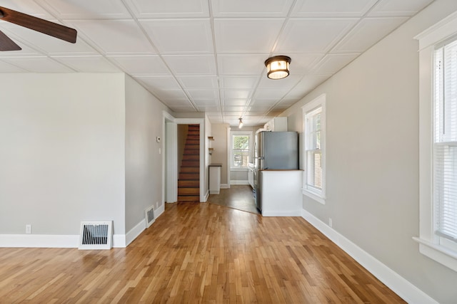 716 17th St, Jackson, MI 49203 - spare room with light wood-type flooring, a ceiling fan, and stairs
