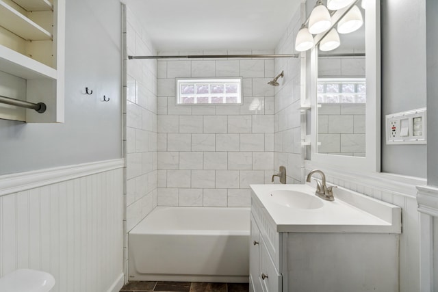 716 17th St, Jackson, MI 49203 - full bathroom with healthy amount of natural light, vanity, tub / shower combination, and a wainscoted wall