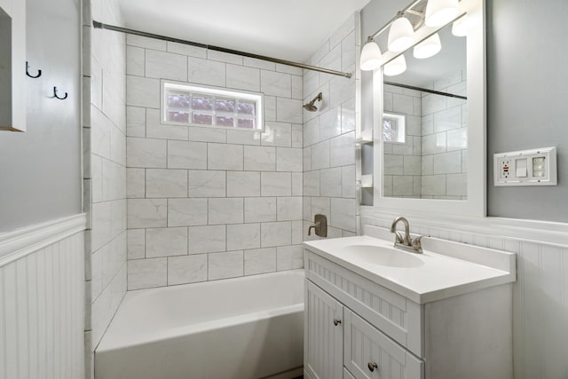 716 17th St, Jackson, MI 49203 - full bath with vanity, shower / bath combination, and a wainscoted wall