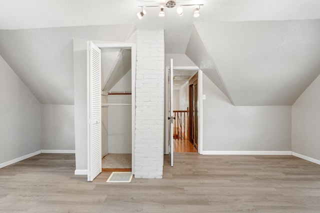 716 17th St, Jackson, MI 49203 - additional living space with lofted ceiling and wood finished floors