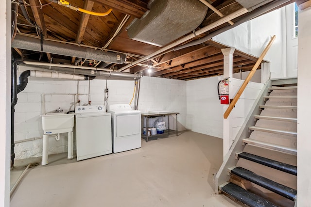 716 17th St, Jackson, MI 49203 - unfinished basement with washing machine and clothes dryer, stairway, and concrete block wall