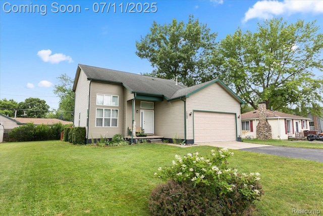 3070 10th St, Monroe, MI 48162 - view of front of property with driveway, an attached garage, and a front lawn