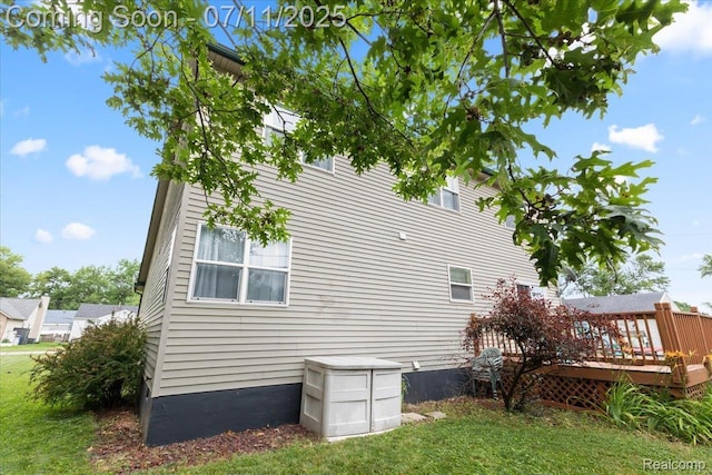 3070 10th St, Monroe, MI 48162 - view of side of property featuring a wooden deck and a lawn