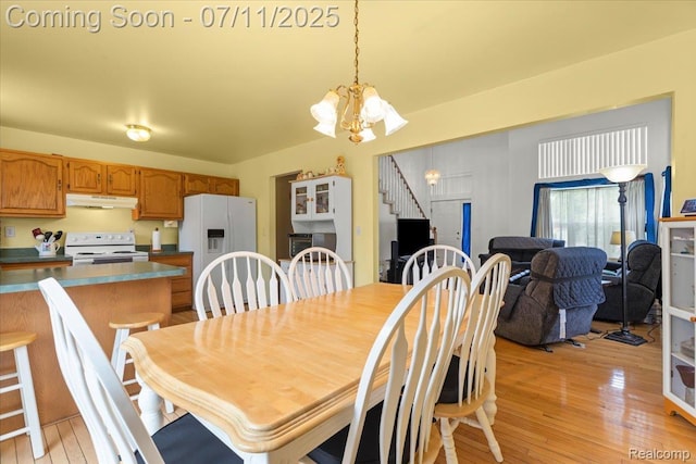 3070 10th St, Monroe, MI 48162 - dining area with a chandelier and light wood-style flooring