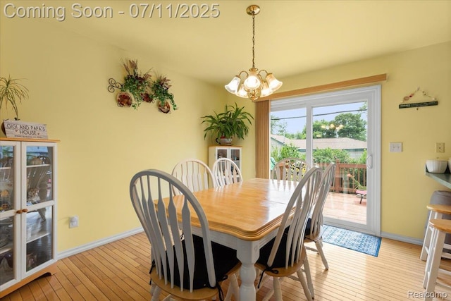 3070 10th St, Monroe, MI 48162 - dining area featuring a chandelier and light wood-type flooring