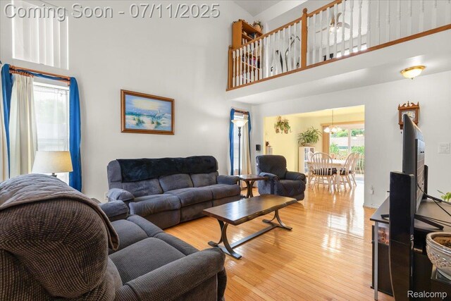 3070 10th St, Monroe, MI 48162 - living room with a towering ceiling, light wood-style floors, and a chandelier