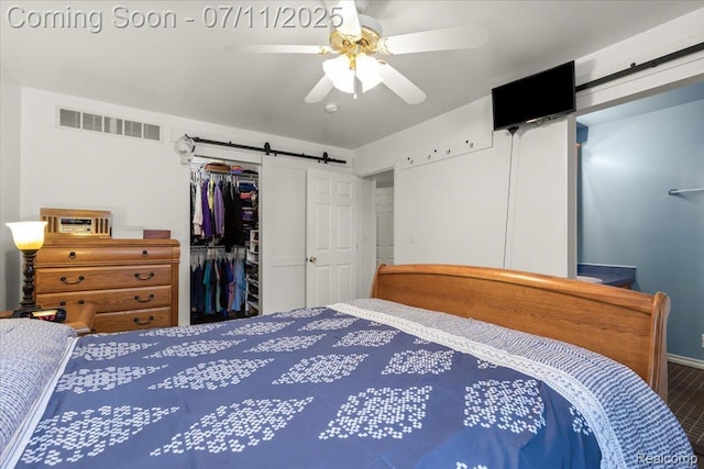 3070 10th St, Monroe, MI 48162 - bedroom with a barn door, a closet, and ceiling fan