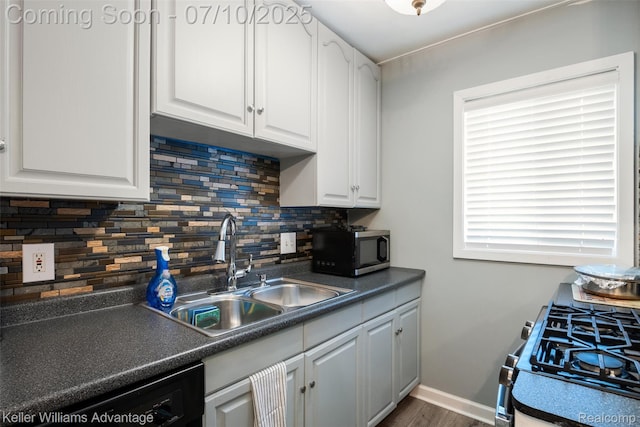 15326 Brookfield St, Livonia, MI 48154 - kitchen with stainless steel microwave, dishwasher, white cabinets, and tasteful backsplash