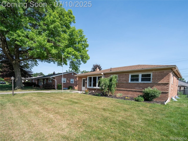 35622 Minton St, Livonia, MI 48150 - ranch-style house with brick siding, a front lawn, and a chimney