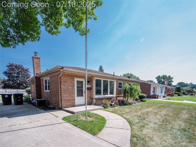 35622 Minton St, Livonia, MI 48150 - ranch-style home featuring brick siding, a chimney, and a front yard