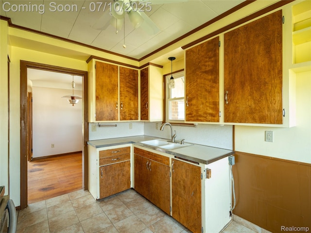 35622 Minton St, Livonia, MI 48150 - kitchen featuring ceiling fan, brown cabinetry, ornamental molding, and light tile patterned floors
