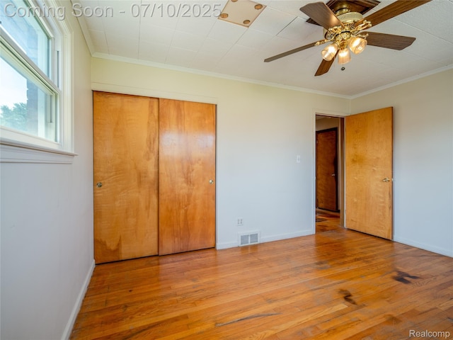 35622 Minton St, Livonia, MI 48150 - unfurnished bedroom featuring wood finished floors, a closet, crown molding, and ceiling fan