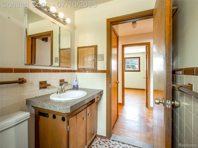 35622 Minton St, Livonia, MI 48150 - half bathroom featuring tile walls, vanity, and wainscoting