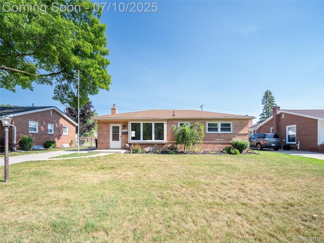 35622 Minton St, Livonia, MI 48150 - ranch-style home featuring a chimney, brick siding, and a front yard