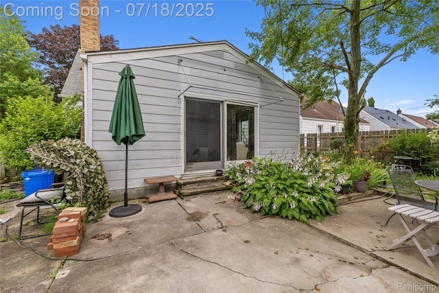 28589 Everett St, Southfield, MI 48076 - rear view of house featuring a patio, a chimney, and entry steps
