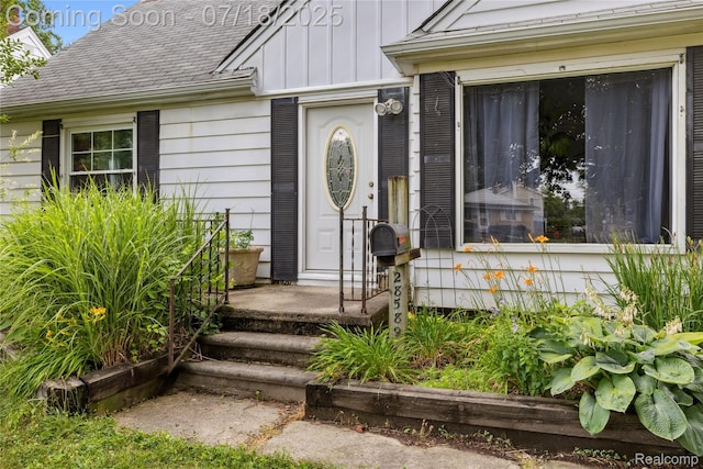 28589 Everett St, Southfield, MI 48076 - view of exterior entry with board and batten siding and a shingled roof