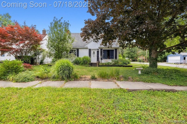 28589 Everett St, Southfield, MI 48076 - view of front of house featuring a front yard and a chimney