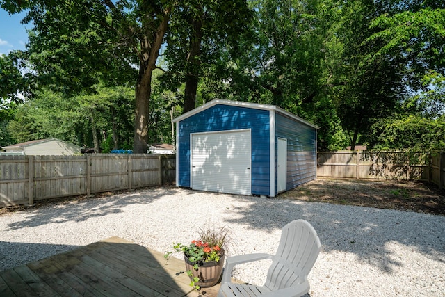 10637 Portage Rd, Portage, MI 49002 - garage with a storage unit and view of wooded area