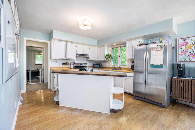 15645 Rich Ln, Hickory Corners, MI 49060 - kitchen featuring appliances with stainless steel finishes, butcher block countertops, light wood finished floors, and white cabinetry