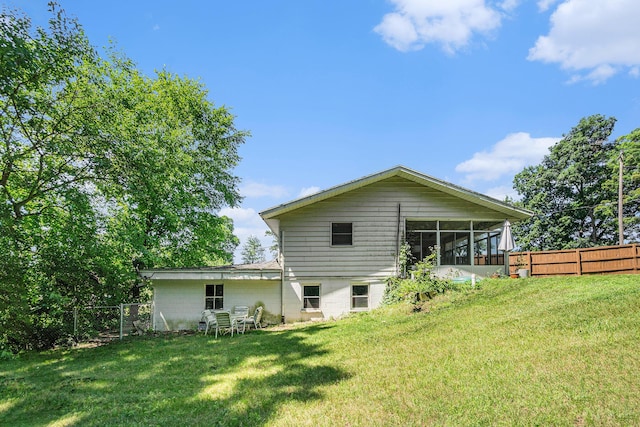 15645 Rich Ln, Hickory Corners, MI 49060 - rear view of house featuring a fenced backyard and a sunroom
