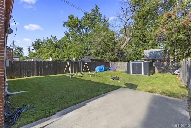 19359 Montrose St, Detroit, MI 48235 - fenced backyard featuring a playground, a patio, and a storage unit