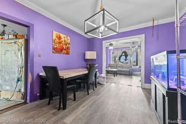 22 W Henry St, River Rouge, MI 48218 - dining room with wood finished floors, crown molding, and a ceiling fan