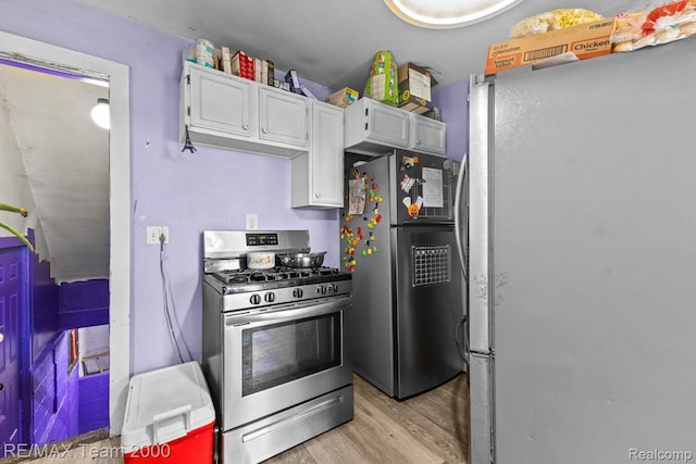 22 W Henry St, River Rouge, MI 48218 - kitchen with appliances with stainless steel finishes, light wood-style flooring, and white cabinets