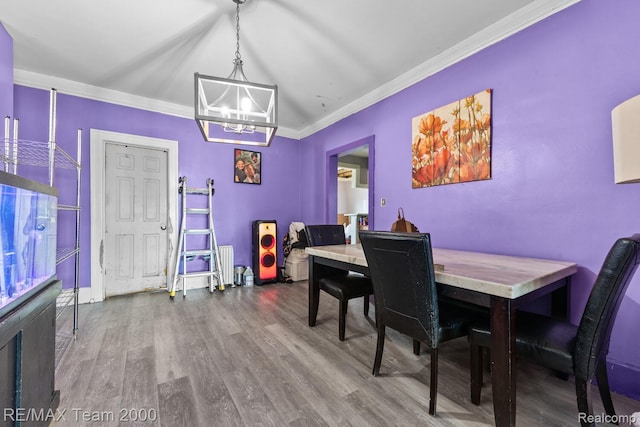 22 W Henry St, River Rouge, MI 48218 - dining space with a chandelier, wood finished floors, and ornamental molding