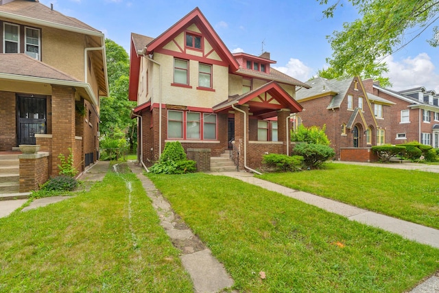 1227 Longfellow St, Detroit, MI 48202 - view of front of property with stucco siding, a front lawn, and brick siding