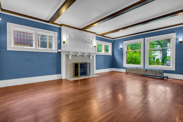 1227 Longfellow St, Detroit, MI 48202 - unfurnished living room featuring radiator, beam ceiling, wood-type flooring, crown molding, and a brick fireplace