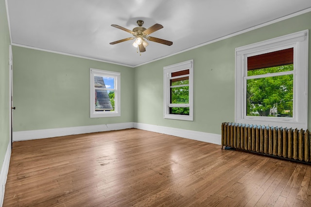 1227 Longfellow St, Detroit, MI 48202 - unfurnished room with radiator heating unit, healthy amount of natural light, crown molding, hardwood / wood-style floors, and ceiling fan