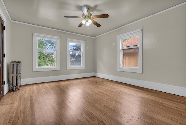1227 Longfellow St, Detroit, MI 48202 - unfurnished living room featuring radiator heating unit, crown molding, hardwood / wood-style flooring, and a ceiling fan