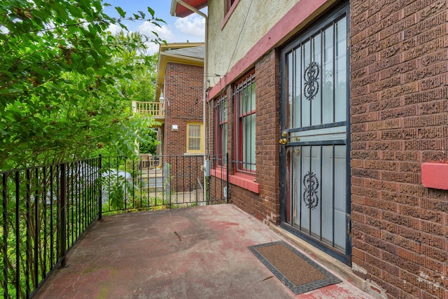 1227 Longfellow St, Detroit, MI 48202 - doorway to property featuring brick siding and a balcony