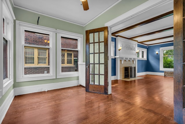 1227 Longfellow St, Detroit, MI 48202 - unfurnished living room featuring radiator heating unit, ornamental molding, wood finished floors, a fireplace with flush hearth, and ceiling fan