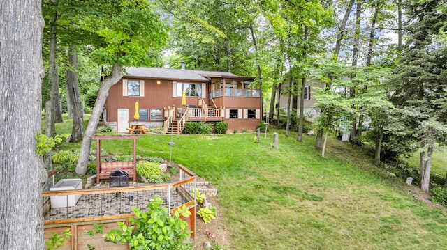 263 Westshore Dr, Jerome, MI 49249 - rear view of property featuring a yard, stairs, a vegetable garden, and a wooden deck