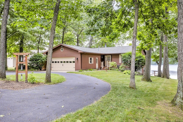 263 Westshore Dr, Jerome, MI 49249 - ranch-style home featuring an attached garage, asphalt driveway, a front lawn, a shingled roof, and a chimney