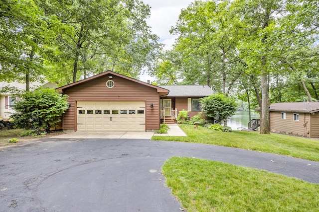 263 Westshore Dr, Jerome, MI 49249 - ranch-style house featuring asphalt driveway, a garage, a front yard, and a water view
