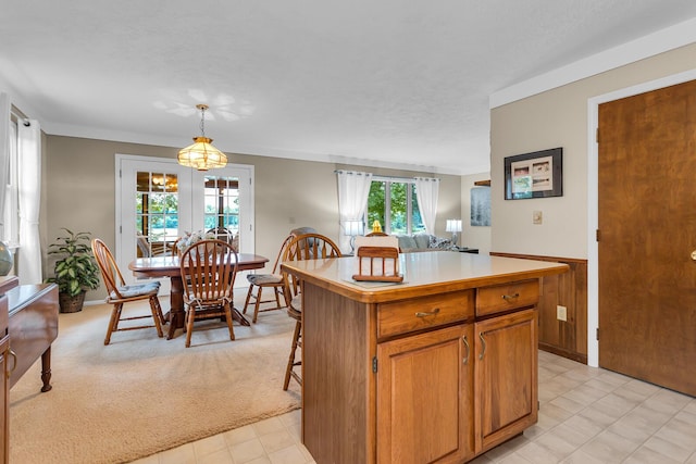 263 Westshore Dr, Jerome, MI 49249 - kitchen featuring light countertops, open floor plan, a center island, pendant lighting, and brown cabinetry