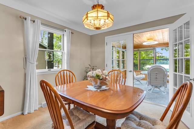 263 Westshore Dr, Jerome, MI 49249 - dining area featuring light carpet, a chandelier, and french doors