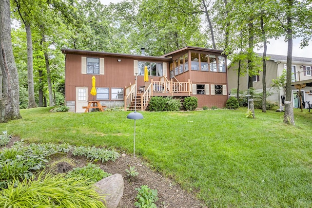 263 Westshore Dr, Jerome, MI 49249 - back of house featuring a sunroom, stairs, and a lawn
