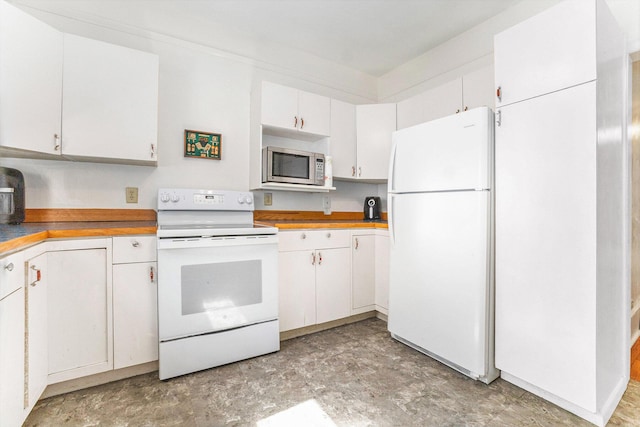 617 E Thorn St, Hastings, MI 49058 - kitchen featuring white appliances, white cabinetry, and light countertops