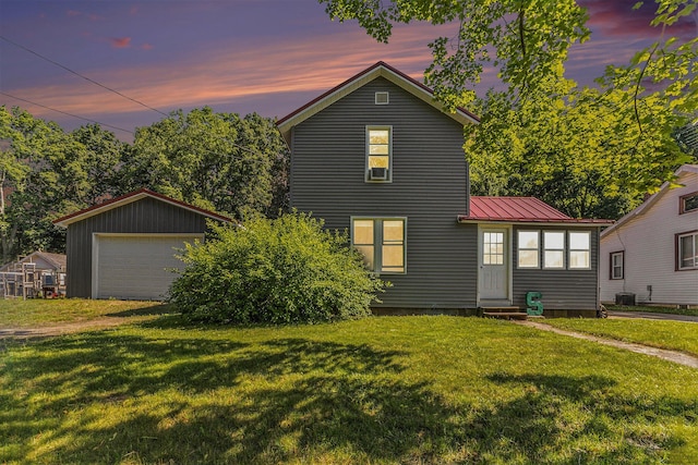 617 E Thorn St, Hastings, MI 49058 - traditional home with entry steps, a detached garage, a front yard, a metal roof, and driveway