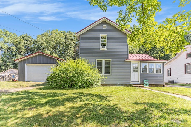 617 E Thorn St, Hastings, MI 49058 - traditional-style home with entry steps, a garage, a front lawn, a metal roof, and an outbuilding