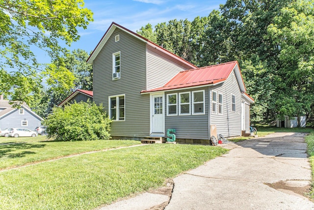 617 E Thorn St, Hastings, MI 49058 - view of front of property with entry steps, a metal roof, driveway, and a front lawn