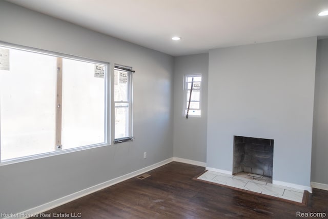 3926 Three Mile Dr, Detroit, MI 48224 - unfurnished living room featuring wood finished floors, recessed lighting, and a tiled fireplace
